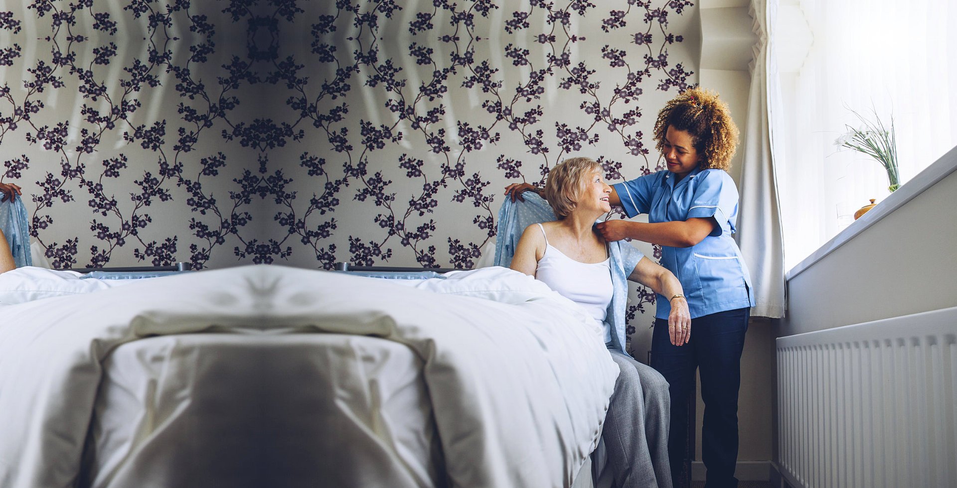 caregiver helping an elder woman